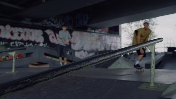 Skateboarder Trying Trick on Rail Outside