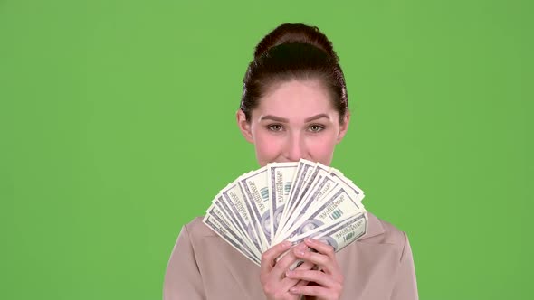 Girl with Banknotes of Money in Her Hands, Winks at the Guy She Likes. Green Screen