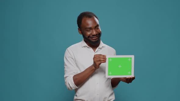 Businessman Showing Horizontal Green Screen on Digital Tablet