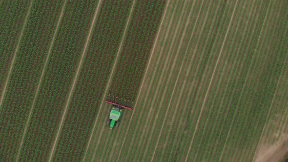 Aerial: Tractor Working on Cultivated Fields Farmland, Industrial Agriculture Occupation