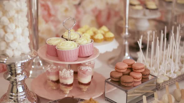 Cute Candy Bar with Various Cakes and Candies. Wedding Candybar.