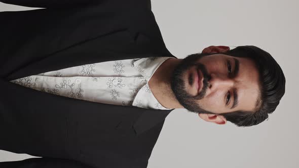 Serious Expressive Angry Latin Businessman in a Tuxedo Crossing His Arms on His Chest