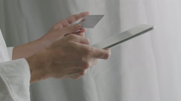 Close-up businessman using tablet purchase online shopping and use a credit card payment.