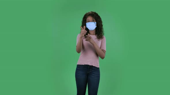 Portrait of Beautiful African American Young Woman in Medical Protective Face Mask Looking at Camera