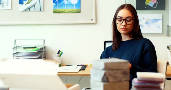 Female executive using mobile phone