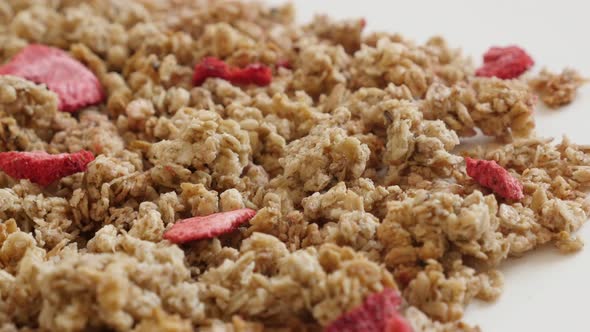 Strawberry flavor muesli on pile close-up 4K 2160p 30fps UltraHD panning footage - Tasty dehydrated 