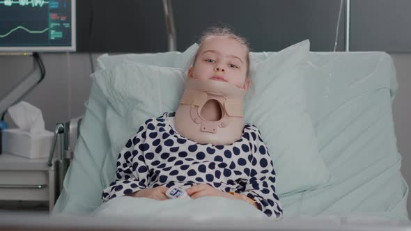 Portrait of Hospitalized Sick Little Child Resting in Bed Wearing Medical Neck Cervical Collar