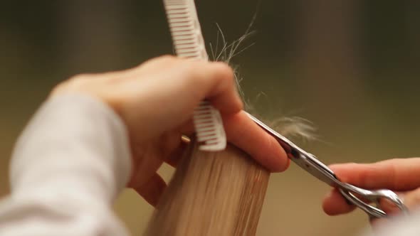 Young Stylish Male Hairdresser Doing Hair Cut for Blonde Woman Outdoors.