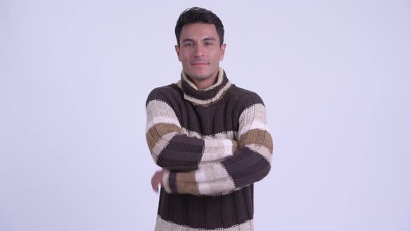 Young Happy Hispanic Man Smiling with Arms Crossed Ready for Winter