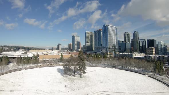 Aerial Hitchcock Zoom On Snow Covered City Park Skyline