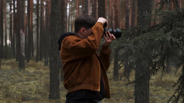 A Photographer Takes Pictures in the Woods a Young Man Takes Pictures in the Woods with His Camera