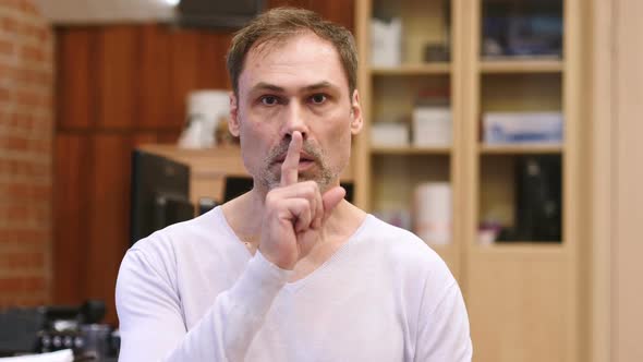 Gesture of Silence By Middle Age Man Finger on Lips