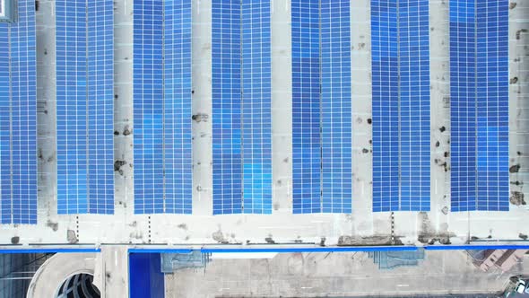 Aerial cinematic view of a solar panel on mall roof top