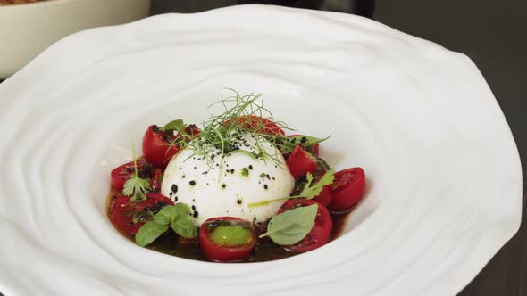 Salad with Burrata Mozzarella Cheese Tomatoes and Leafs of Salad