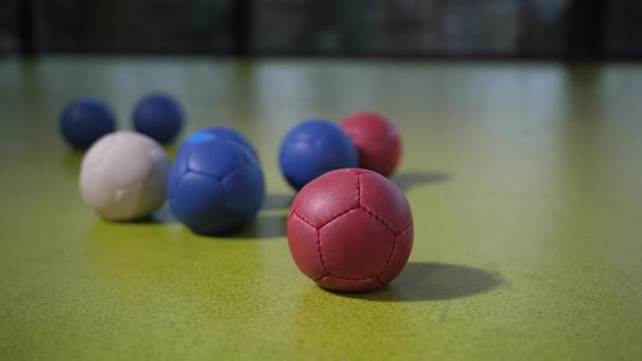 Colored Boccia Balls on Floor Surface During Game