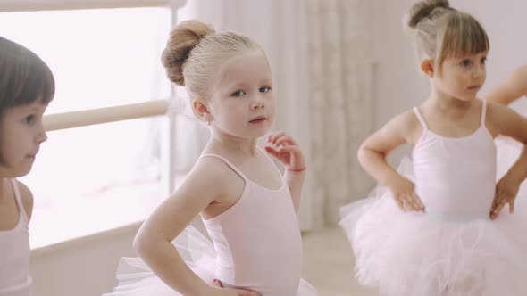 Little Girls Bending Together in Ballet Class