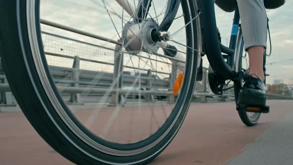 Close Up Female Feet in Shoes Cycling By Bike in City on Bridge in the Morning