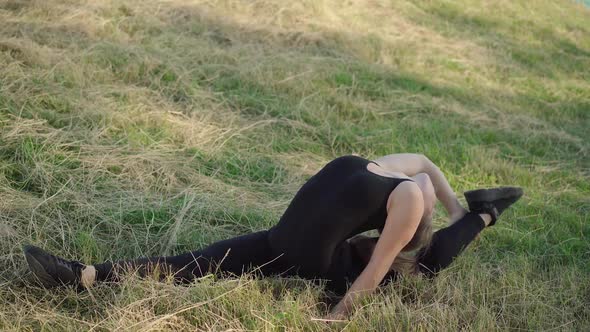 Backbend of Extremely Flexible Caucasian Woman Sitting in Side Split Outdoors. Wide Shot of Slim