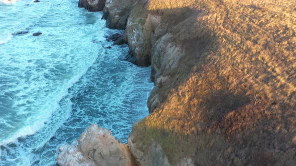 Aerial view to a beautiful wild rocky beach and big waves