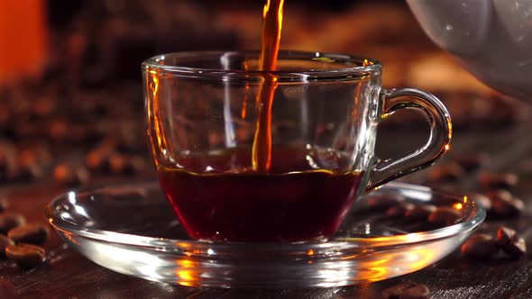 Closeup. Black Coffee Is Poured Into a Glass Transparent Cup