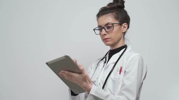 Young Female Doctor Tracking Patients Symptoms at Medical Facility
