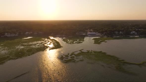 Drone dolly shot of Murrells Inlet SC at sunset over a creek