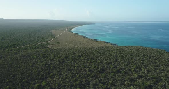 Incredible aerial shot over Cabo Rojo Flint with a view of the horizon, green areas in a beautiful m