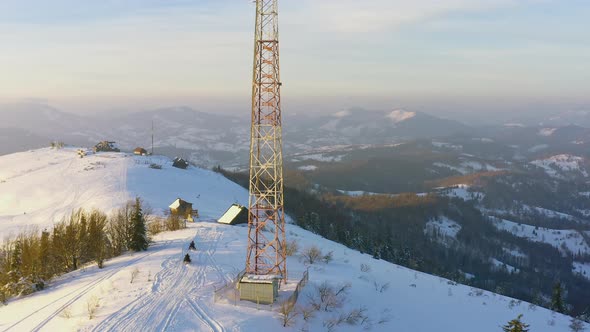 Flying Over Radio Communications Tower Mountain Snow Covered Winter Landscape