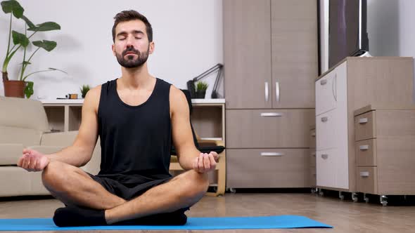 Man at Home Practicing Yoga in the Living Room