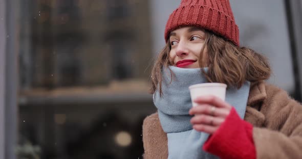 Woman Drinking Hot Drink at the Cafe in Winter