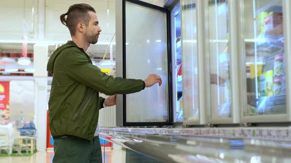 Man Buying Frozen Food in the Supermarket