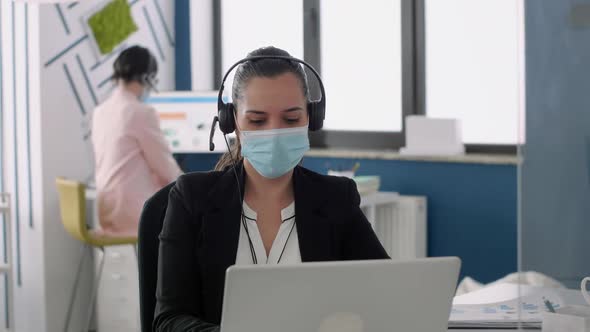 Businesswoman with Protection Face Mask Talking Into Microphone