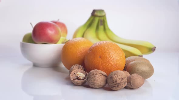 Woman Lays Fruits and Nuts on the Table 