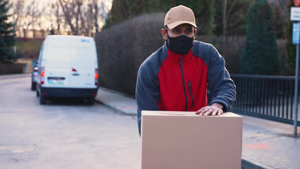 Man with Face Mask Delivering Package