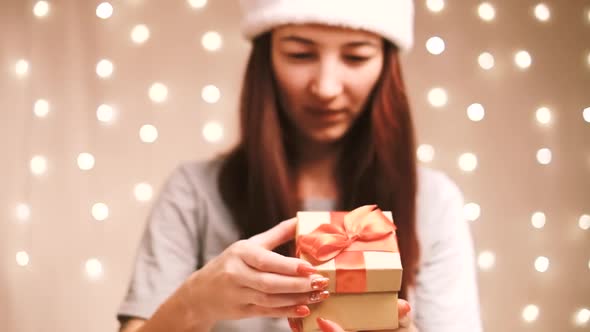 Woman Opening a Gift Box and Smiling