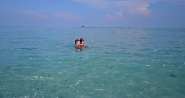 Young couple on romantic honeymoon enjoy life on beach on paradise white sand 4K background