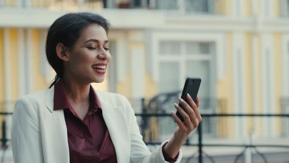 Smiling Businesswoman Having Video Chat Outside