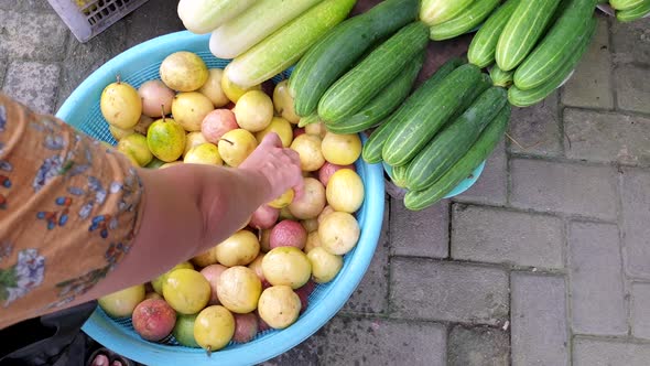 Picking and buying passionfruit at the local fruit and vegetable produce market on a tropical island