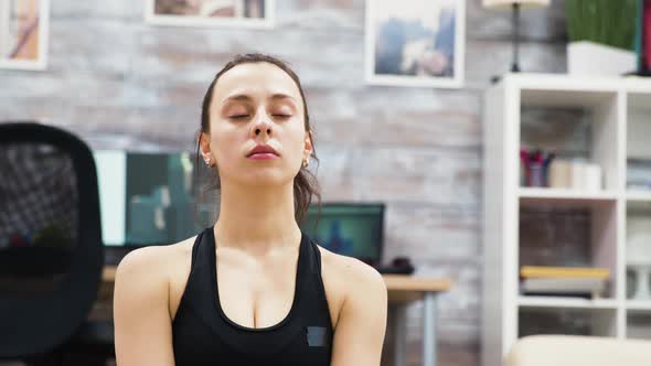 Young Woman Practicing Yoga Meditation with Eyes Closed