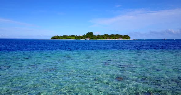 Tropical fly over abstract shot of a white sand paradise beach and blue sea background in hi res 4K