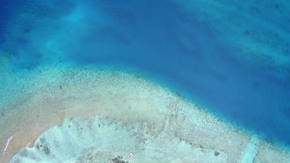 Drone aerial scenery of shore beach by blue sea and sand background