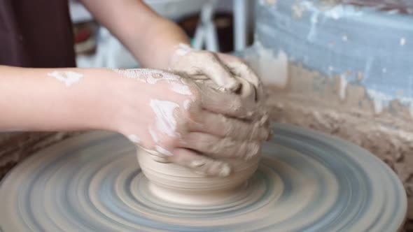 Creating a Clay Pot. Potter. Workshop of Clay, Clay on the Device, Hands Working on Pottery Wheel