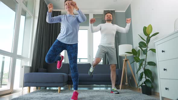 Caucasian Couple is Doing Cardio Exercise at Home in Cozy Bright Room Slow Motion