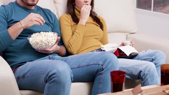 Couple Sitting on Couch Eating Fried Chicken