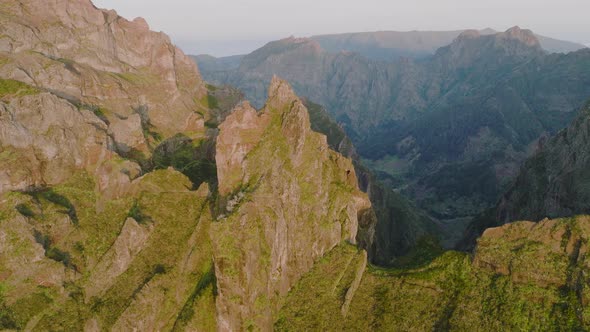 Jagged mountain peaks in rugged terrain, Pico do Areeiro trail, Madeira; drone