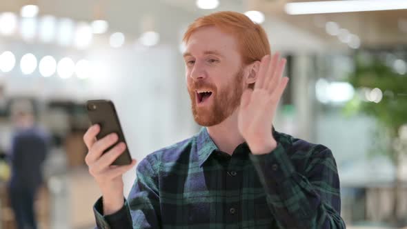 Portrait of Beard Redhead Man Doing Video Call on Smartphone