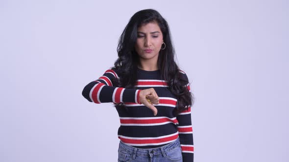 Young Sad Persian Woman Giving Thumbs Down