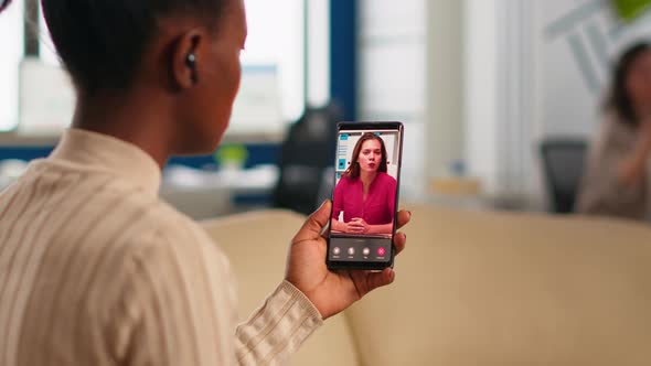 Back View of African Woman Discussing with Remote Manager on Video Call