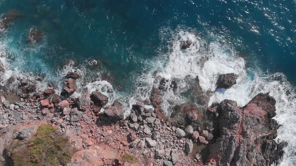 Rocky coastline and sea waves. Huge powerful sea waves breaking on rocky edge of seashore