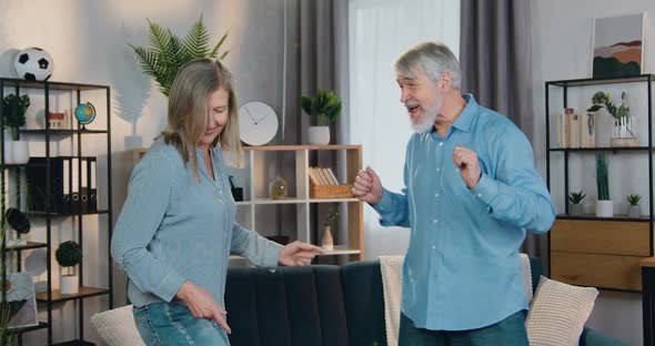 Carefree Aged Man and Woman Enjoying Active Dance